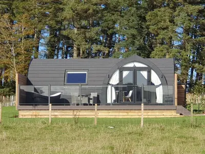 a black and white house with a window at East Rigg Lodges in Balerno