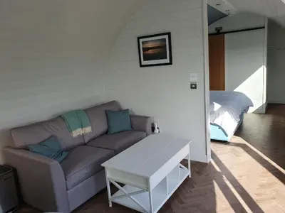 a living room with a couch and a bed at East Rigg Lodges in Balerno