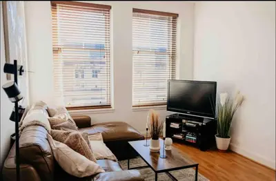 a living room with a couch and a tv at Glasgow City 1 Bedroom Apartment in Glasgow