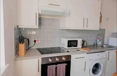 a kitchen with a sink and a stove top oven at Glasgow City - 1 Bedroom Apartment in Glasgow
