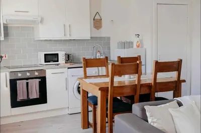 a kitchen with a table and chairs and a couch at Glasgow City - 1 Bedroom Apartment in Glasgow