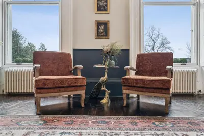 two chairs in a living room with windows at Grand 2 Bed West End Residence in Glasgow