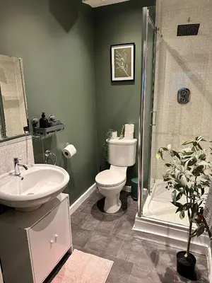 a bathroom with a toilet and a sink and a shower at Stylish 2 bed City Retreat in Glasgow