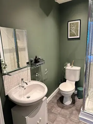 a bathroom with a white sink and a toilet at Stylish 2 bed City Retreat in Glasgow
