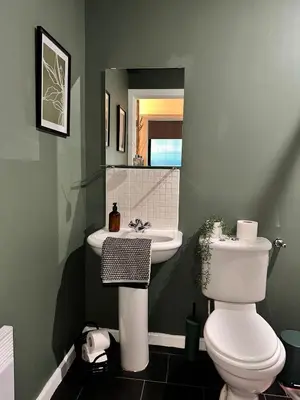 a bathroom with a white toilet and a sink at Stylish 2 bed City Retreat in Glasgow