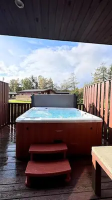 a hot tub sitting on top of a deck at Wild Jungle Retreat in Kirn