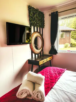 a bedroom with a bed and a mirror and a window at Wild Jungle Retreat in Kirn