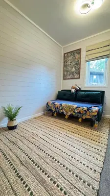 a bedroom with a bed and a large rug at Wild Jungle Retreat in Kirn