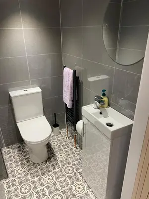 a bathroom with a white toilet and a sink at Garden flat in Largs
