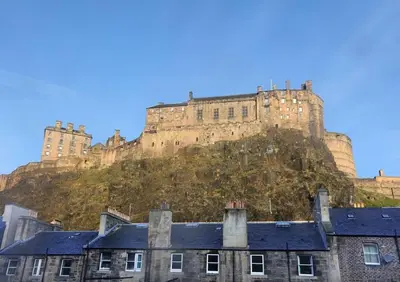 a castle on top of a hill with buildings at Grassmarket Apartment with Amazing Castle View in Edinburgh