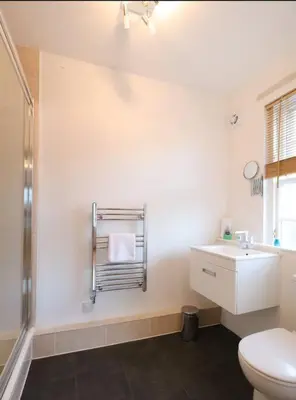 a bathroom with a toilet and a sink and a shower at Grassmarket Apartment with Amazing Castle View in Edinburgh