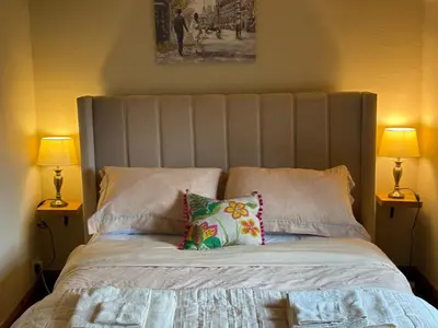 a bed with two lamps and two pillows on it at 11 George Street Doune in Stirling