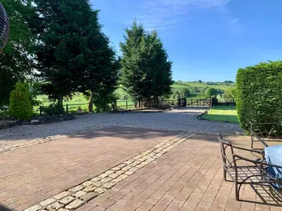 a park with a bench and trees and a fence at WestLaigh Central Scotland with outdoor BBQ Hut, pets welcome in Strathaven