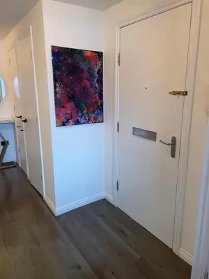 a painting on the wall of a room with a door at Harbour bliss in Ardrossan