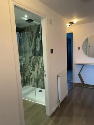 a glass shower in a room with a hallway at Harbour bliss in Ardrossan