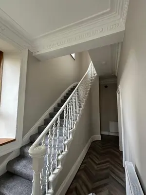 a staircase in a home with white railings at Spacious 5 Bedroom House Close to Central West End in Glasgow