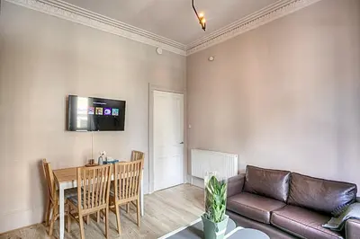 a living room with a couch and a table at Charming 2 Bed Apartment in the heart of the West End in Glasgow