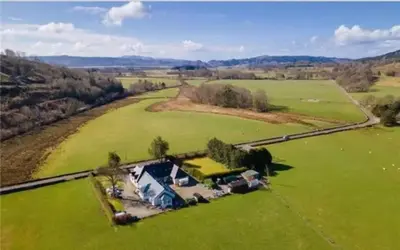 an aerial view of a house in a green field at Wagtail Cottage in Kilmartin