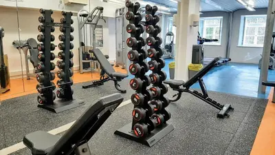 a gym with several treadmills and cardio machines at New Lanark Self Catering Waterhouses in Lanark
