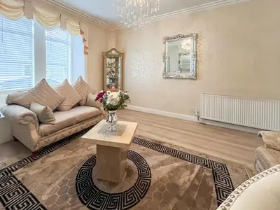 a living room with a couch and a table at Beachcomber Apartment in Girvan