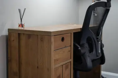 a wooden desk with a black chair next to it at 2-Bed Flat Wishaw Free Parking Family-Friendly in Wishaw