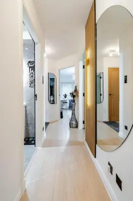 a hallway with a large mirror on the wall at The Pad in Paisley