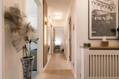 a hallway with a vase with a plant in it at The Pad in Paisley