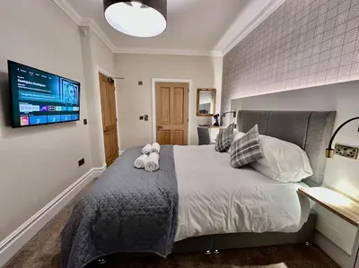 a bedroom with a bed with two stuffed animals on it at Spectacular 2 bed, 2 bath in Edinburgh City Centre in Edinburgh