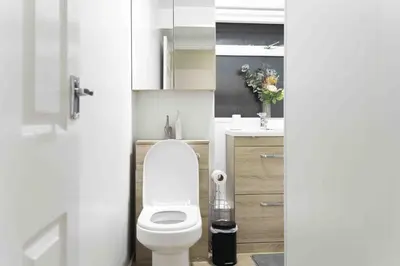 a bathroom with a white toilet and a sink at Montgomery Avenue in Paisley