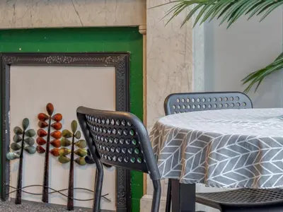 a table and two chairs next to a table and a fireplace at Wonderful West End - Pass the Keys in Glasgow