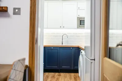 a kitchen with a blue sink and a window at Large bedroom, close to Airport and City Centre in Edinburgh