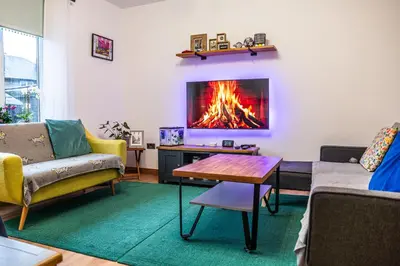 a living room with a fire in the wall at Large bedroom, close to Airport and City Centre in Edinburgh