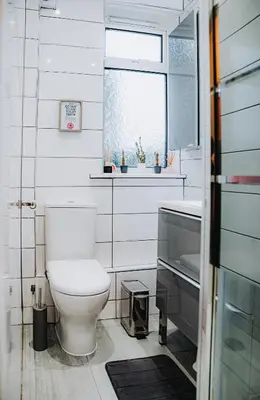 a bathroom with a toilet and a sink and a window at Large bedroom, close to Airport and City Centre in Edinburgh
