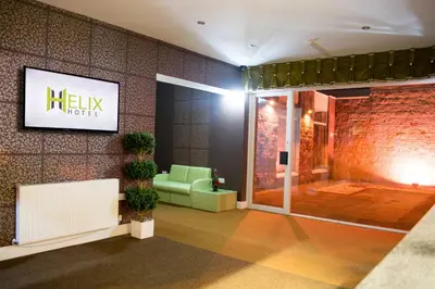 a lobby of a hotel with a couch and a tv at Helix Hotel in Grangemouth