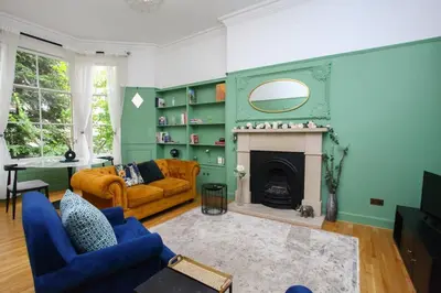 a living room with a couch and a fireplace at Lovely spacious 2 Bed Flat in Glasgow
