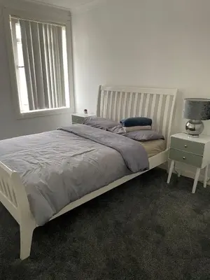 a bedroom with a white bed and a window at 3 bedroom terraced house in Larkhall