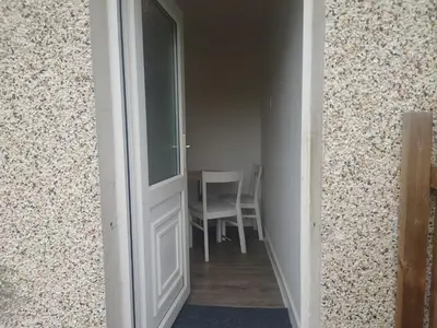 a door to a room with a table and a chair at 3 bedroom terraced house in Larkhall