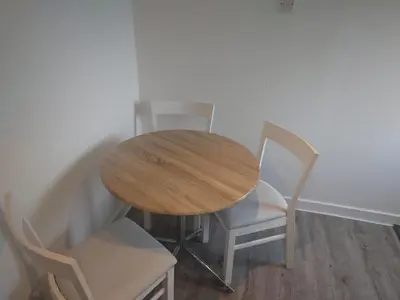 a wooden table and chairs in a room at 3 bedroom terraced house in Larkhall