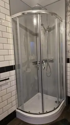 a shower with a glass door in a bathroom at 175 On Clyde - Spacious & Cosy Cedar Wood Bungalow in Helensburgh