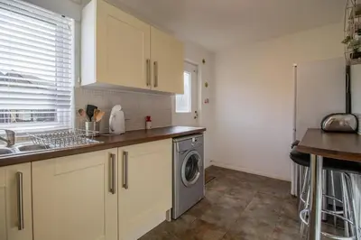 a kitchen with a sink and a washing machine at Lena House in Glasgow