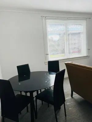 a dining room with a table and chairs and a window at Blue Heaven Apartments in Edinburgh