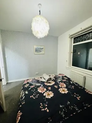 a bedroom with a bed with a phone on it at Blue Heaven Apartments in Edinburgh
