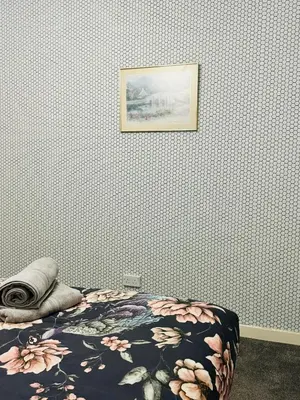a bedroom with a bed and a picture on the wall at Blue Heaven Apartments in Edinburgh