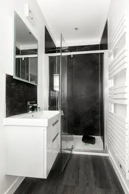 a white bathroom with a shower and a sink at Castle Street Apartments - Luxury Ettrick Apartment in Rothesay