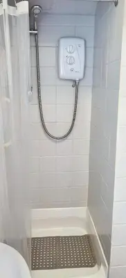 a bathroom with a shower with a toilet and a sink at Quiet Street's Flat with free Parking near Town Centre in Largs
