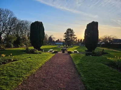 a walkway in a park with trees and grass at Quiet Street's Flat with free Parking near Town Centre in Largs