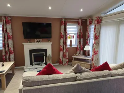 a living room with a couch and a fireplace at Muirfield cosy retreat in Girvan