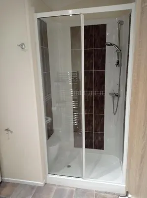 a shower with a glass door in a bathroom at Muirfield cosy retreat in Girvan