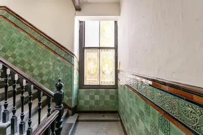 a staircase in an old building with a window at Boutique West End Apartment - 'The Nook' in Glasgow