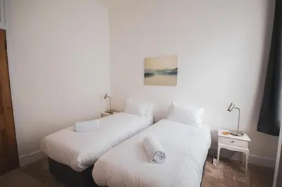 two beds sitting next to each other in a room at Stunning 3 Bed Flat in the Heart of the West End in Glasgow